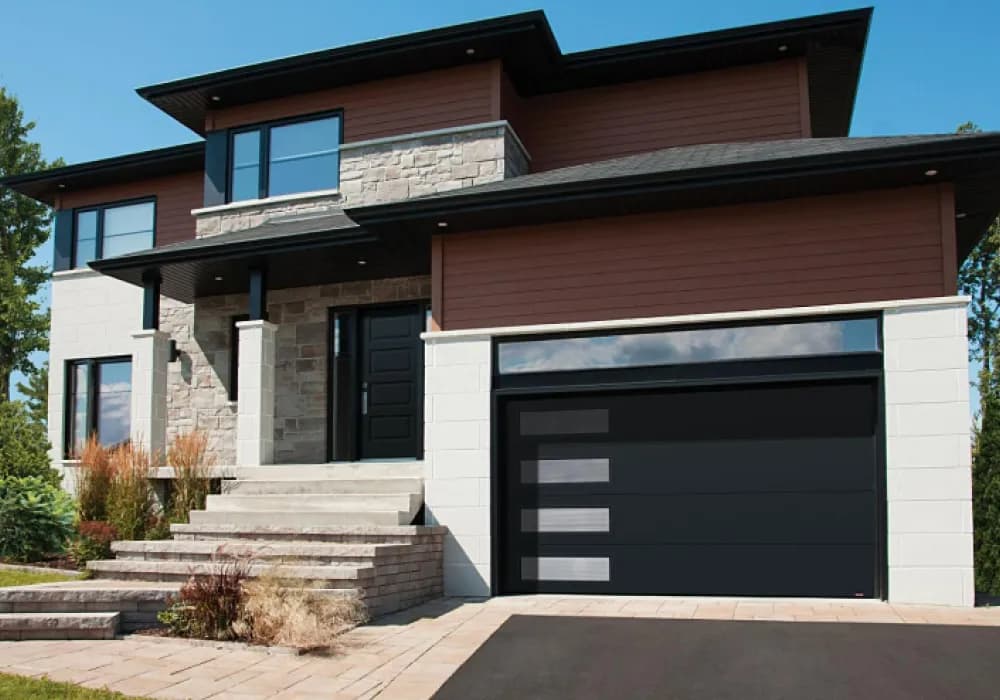 Black sectional garage door with horizontal frosted-glass panels on a modern two-story home